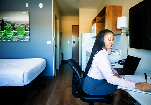 business woman working at a desk in hotel room